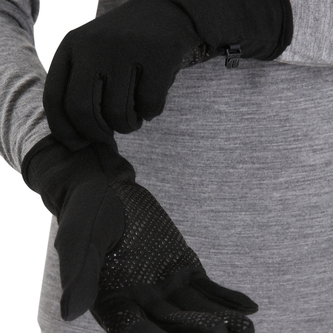 Person wearing Icebreaker black gloves with textured palm
