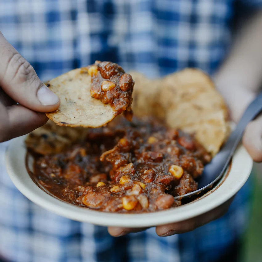 Man eating Back Country Spicy Beef Nachos