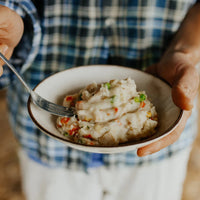 Back Country Tasty Chicken Mash Being Held By Man