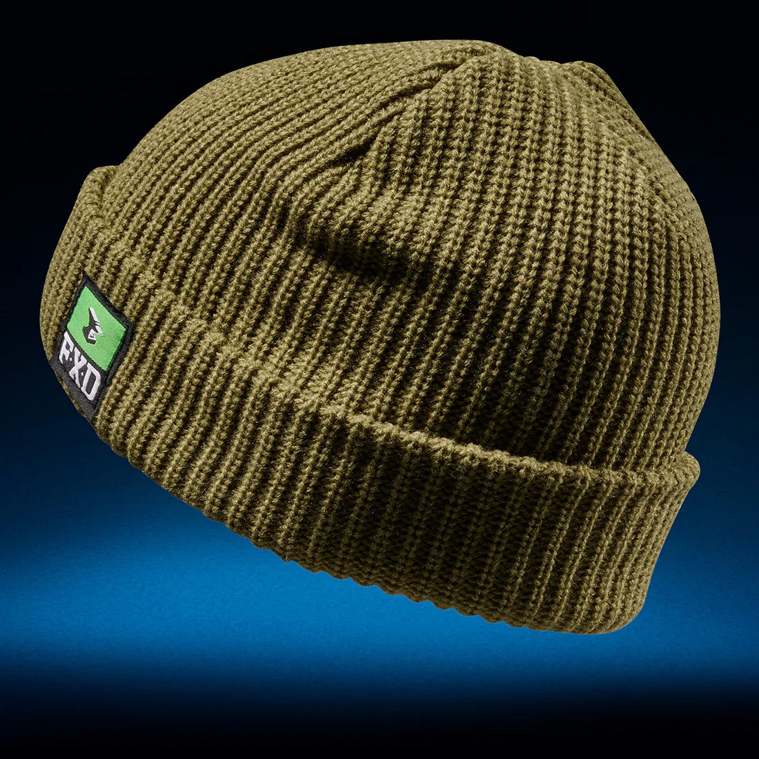 A sage FXD CP-10 knit ribbed beanie with a turn-up cuff and a branded woven label on the side.