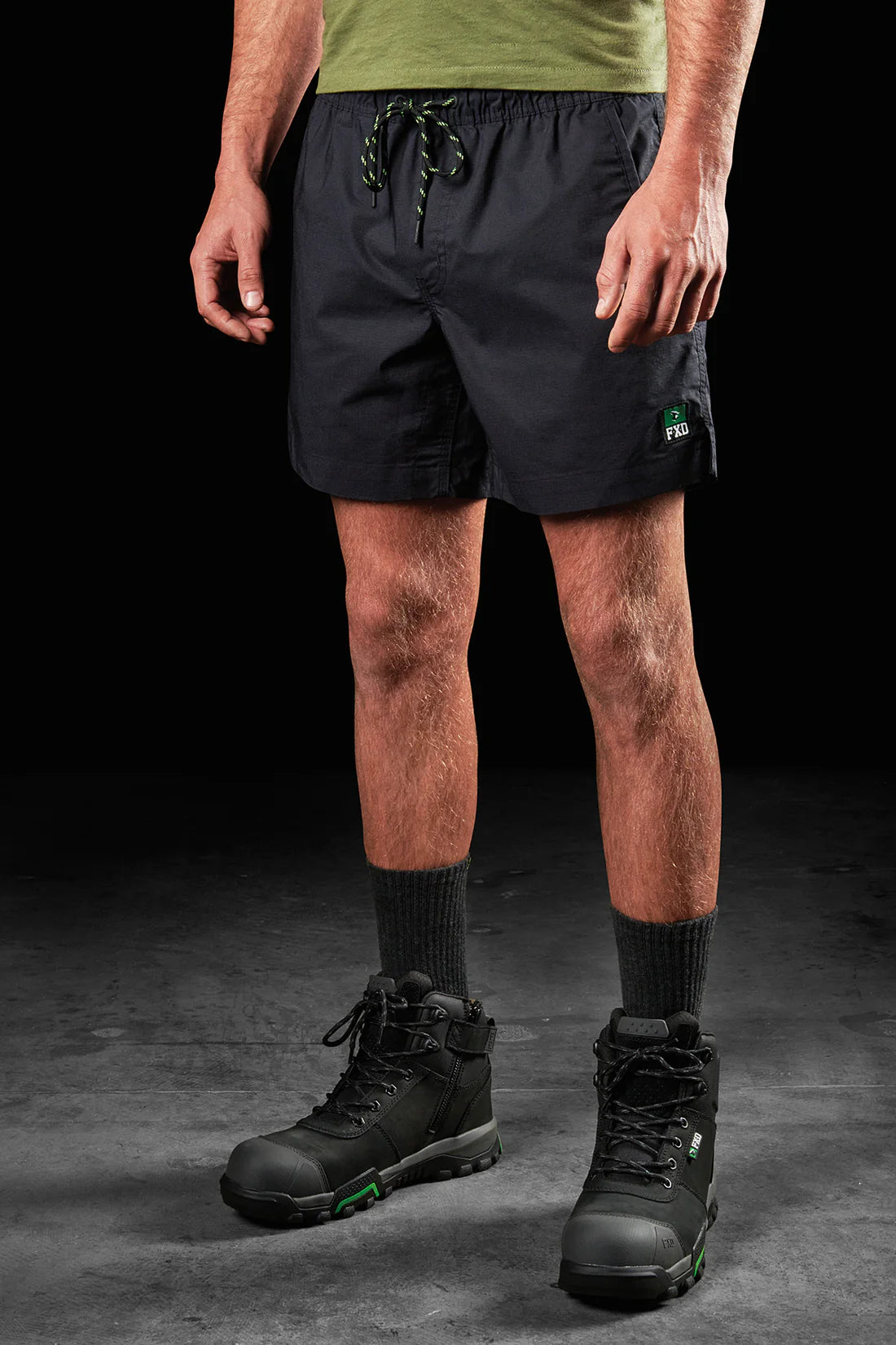 Model wearing FXD WS-4 Men's Repreve Stretch Ripstop Work Shorts in Black