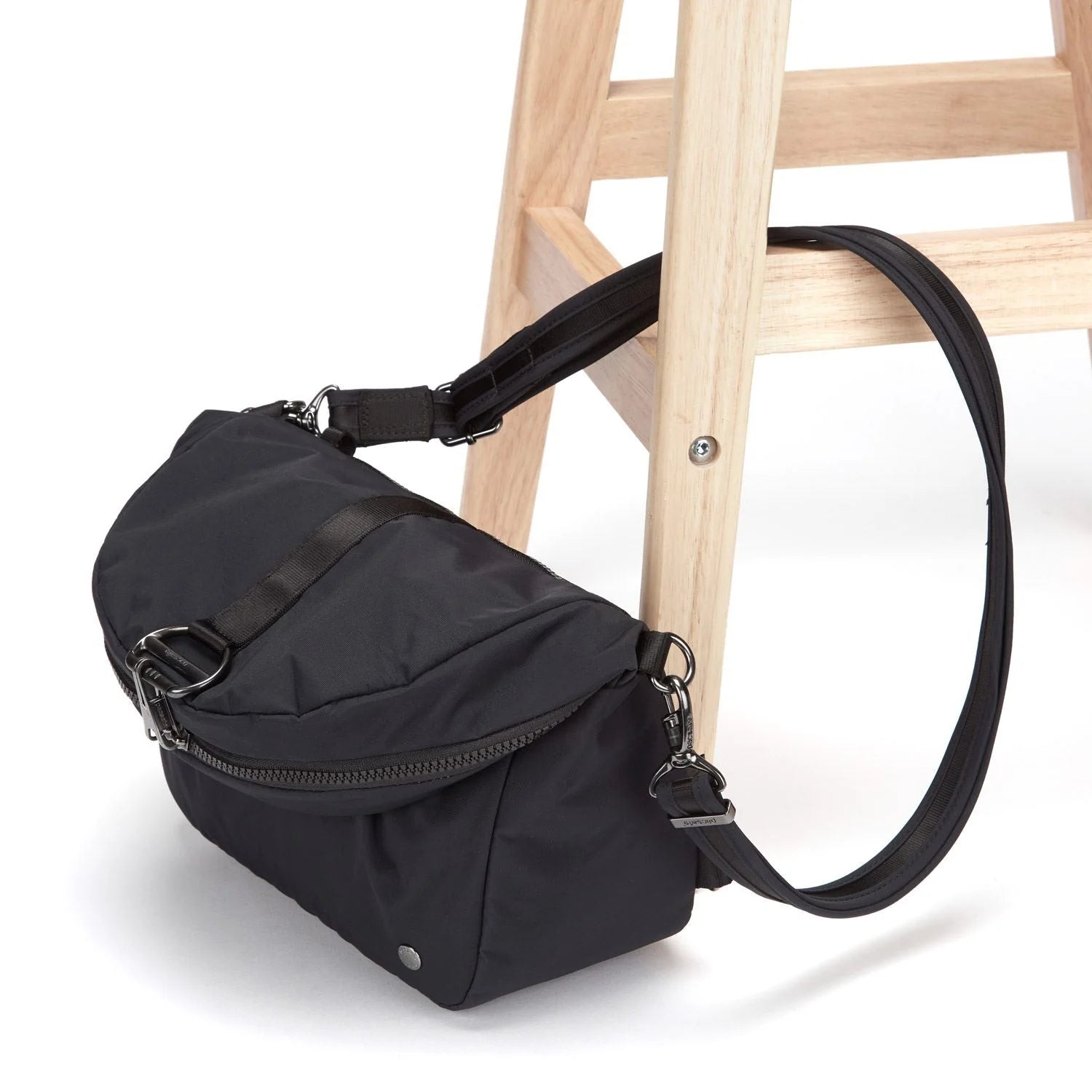 Pacsafe Citysafe CX Econyl Convertible Backpack attached to chair leg