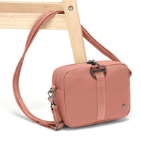 Rose Pacsafe Citysafe CX Square Crossbody Bag attached to chair leg