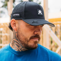 A man wearing a black Anthem A Frame Performance Washable Hat with the brand logo visible on the front.