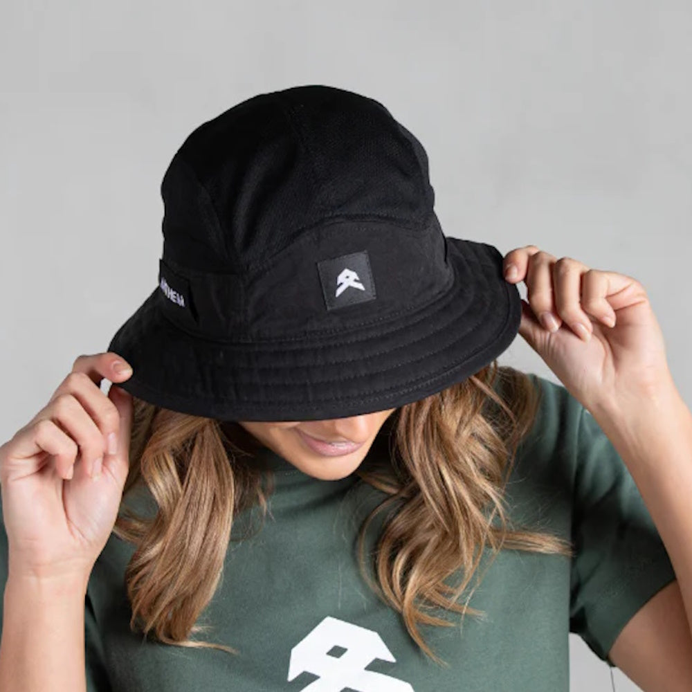 A person wearing a black bucket hat with the Anthem brand logo visible on the front.