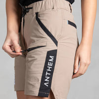 Front pocket being unzipped on Anthem Womens Triumph Shorts in Khaki