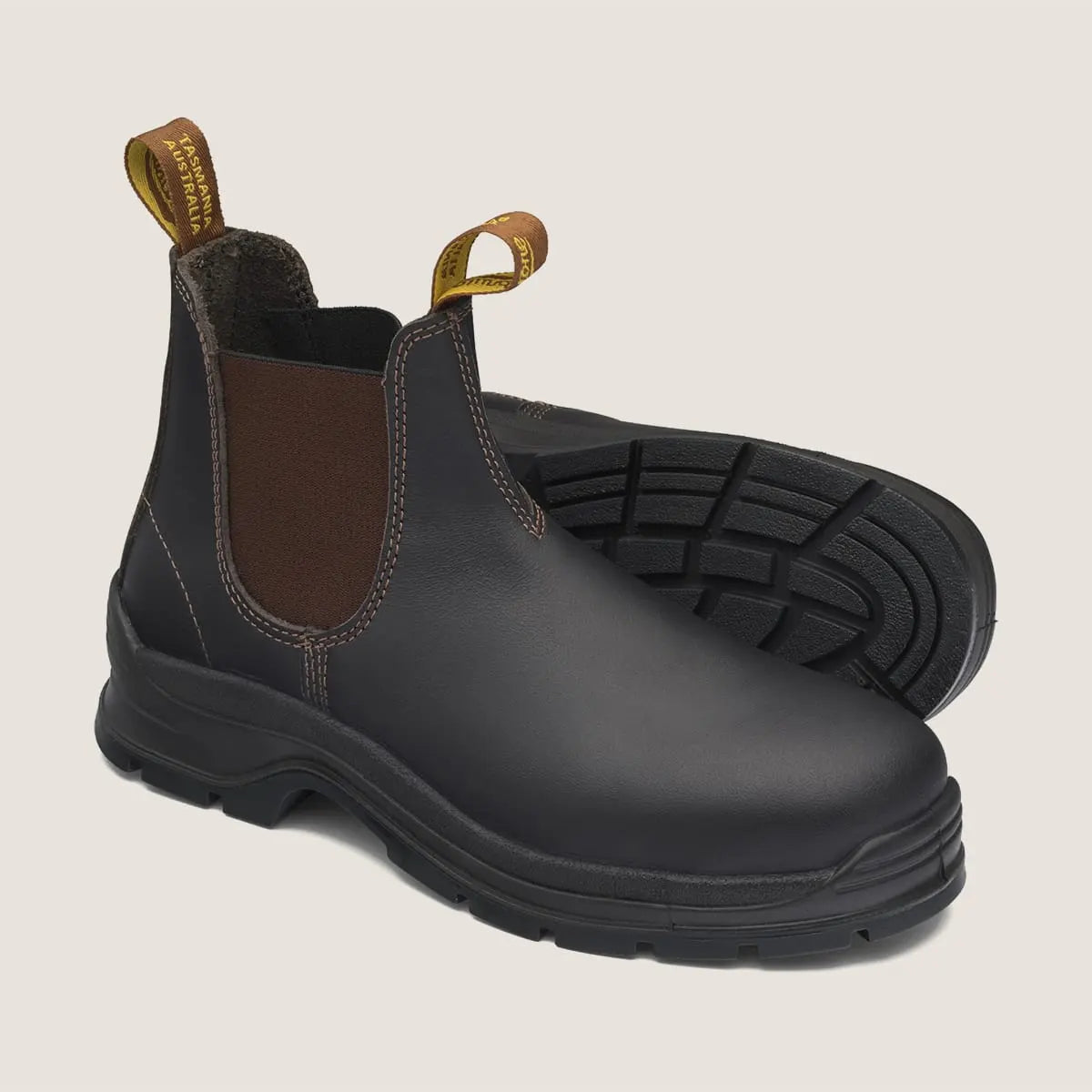 A brown elastic sided safety boot with a steel toe-cap and shank, featuring a side pull tab and a rubber sole.