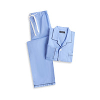A long-sleeve dusk blue Contare pyjama set with a collar and a single chest pocket, and matching blue pants with a straight fall from the hips, a concealed button fly-front, and an elastic waistband.