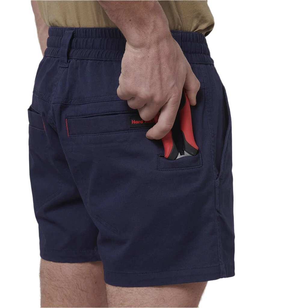 Back view of tool being placed in pocket of Hard Yakka Toughmaxx Short Shorts