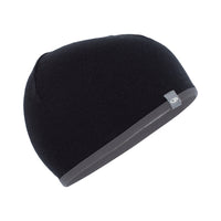A black and grey reversible merino wool beanie by Icebreaker.