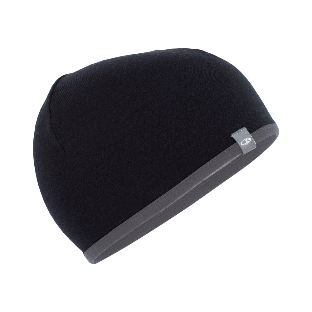 A black and grey reversible merino wool beanie by Icebreaker.