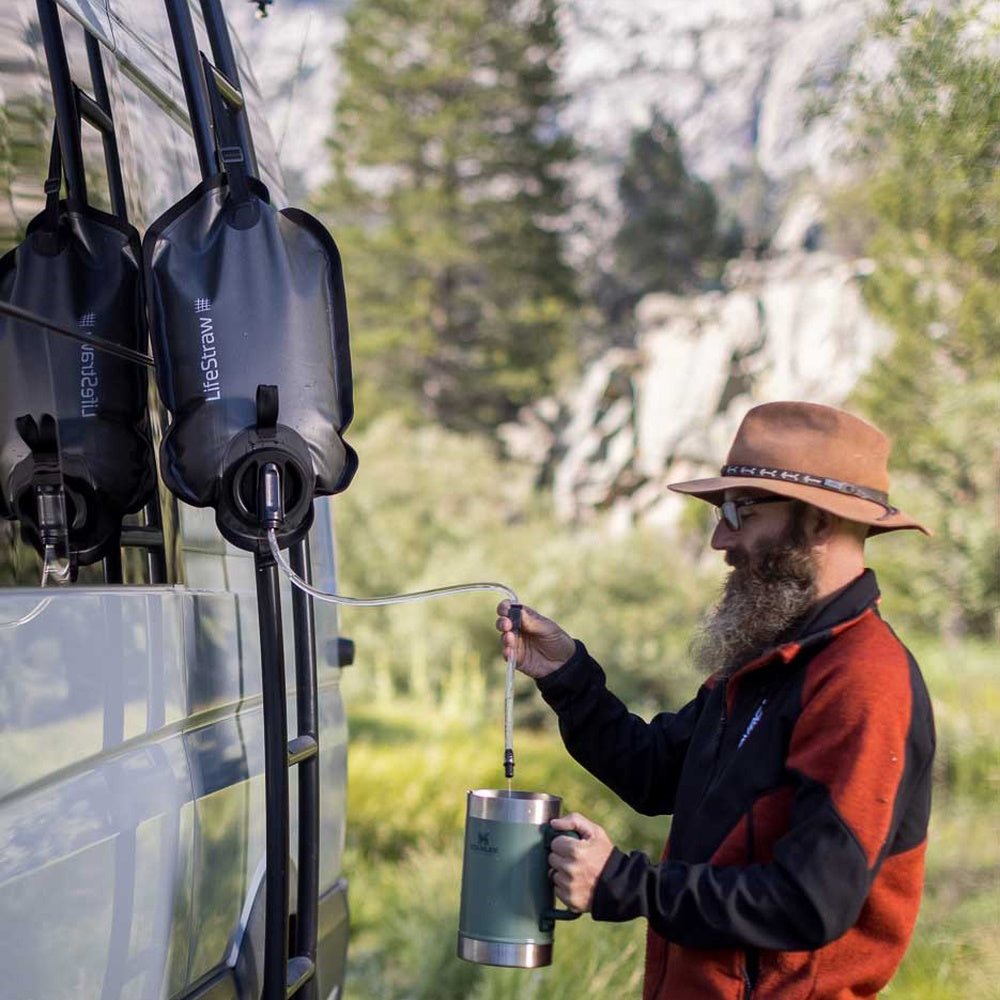 Man using LifeStraw Gravity Water Filter to fill mug