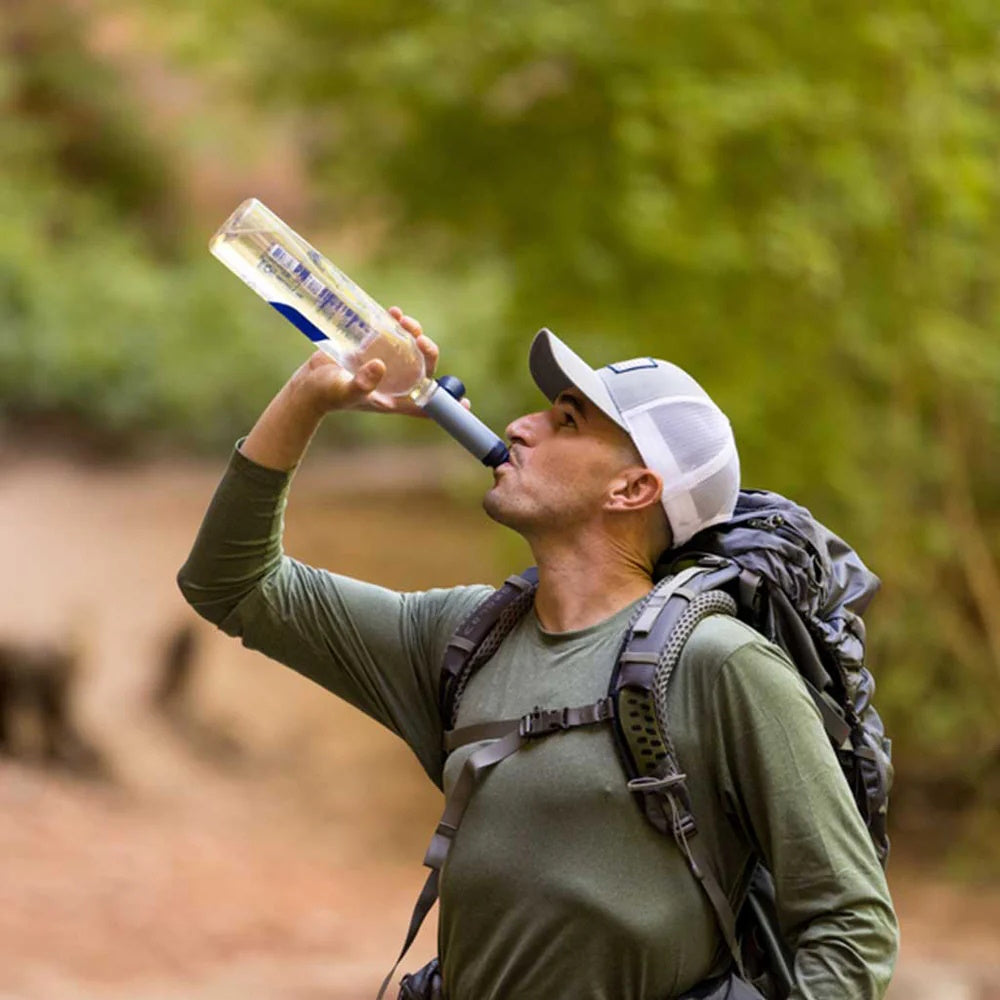 Man drinking a plastic water bottle thru a LifeStraw Peak Series SOLO Water Filter