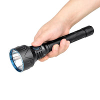 Thumb pressing power button of Olight torch