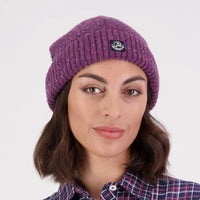 Woman wearing a purple Swanndri South Rd Waffle Beanie with a brand patch on the front.