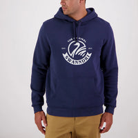 A man wearing a navy blue Swanndri hoodie with a front pouch and a logo print on the chest.