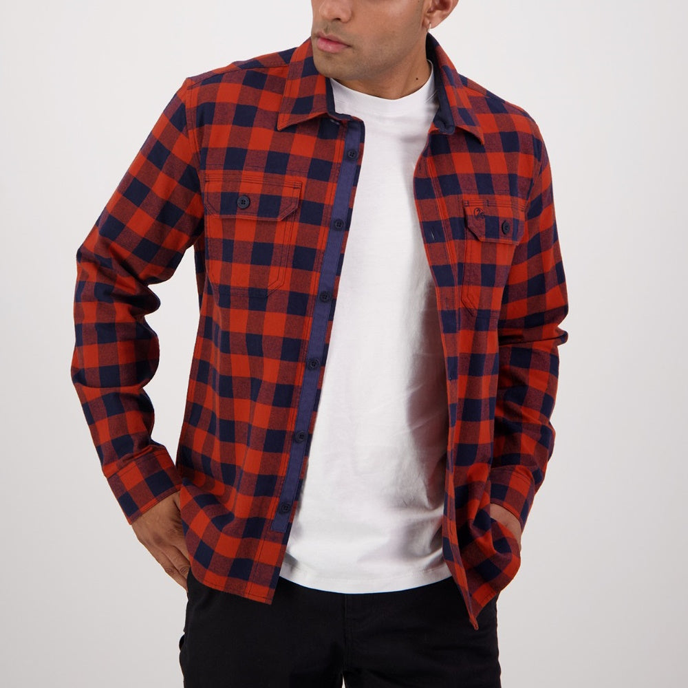 Person wearing a red and blue plaid Swanndri shirt over a white t-shirt