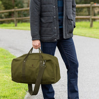 Man holding Olive Thomas Cook Rove Duffle Bag