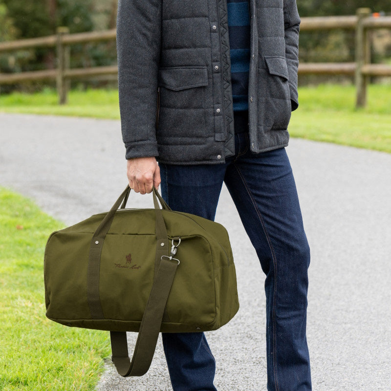 Man holding Olive Thomas Cook Rove Duffle Bag