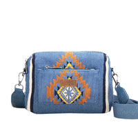 Blue Wrangler Maya Aztec crossbody bag with an Aztec pattern on the front panel, featuring a detachable and adjustable strap.