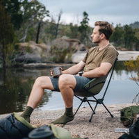 Man sitting in Alton Goods Ultralight Camp Chair