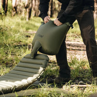 Man using Alton Goods Ultralight Pump Bag to inflate mattress