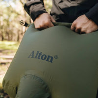 Man pushing down on Alton Goods Ultralight Pump Bag