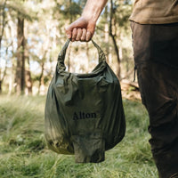Man holding deflated Alton Goods Ultralight Pump Bag