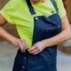 Close up of woman buttoning up Green Hip Womens Overalls