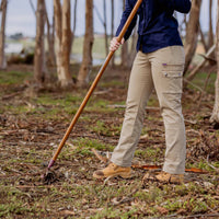 Model wearing Green Hip Womens Give Cargo Pants while doing gardening