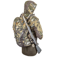 Hunters Element Canyon Pack displayed with camo jacket and rifle