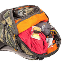 Main compartment open, showing clothing, snacks and a box of bullets