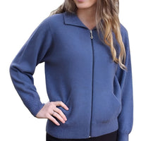 Female model wearing a light blue Lothlorian plain zip cardigan with hand on hip.