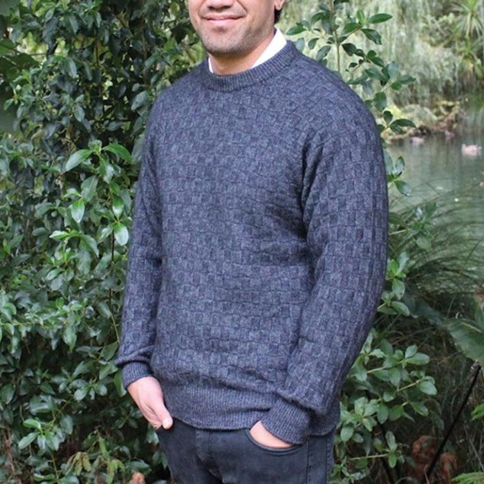 Male model wearing Lothlorian Crew Neck Purl Jumper that is made from possum and merino wool in denim colour.