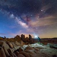 Man holding lantern under starry night
