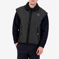 Front view of model wearing Swanndri Foxton Oilskin Vest in Black