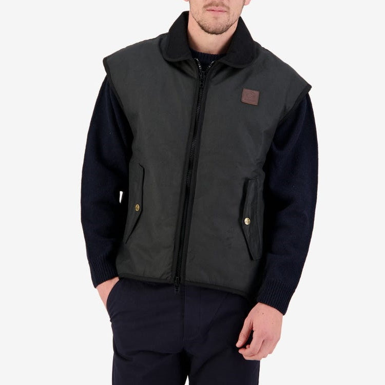 Front view of model wearing Swanndri Foxton Oilskin Vest in Black