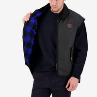 Model opening Swanndri Foxton Oilskin Vest in Black to show Blue & Black check lining.