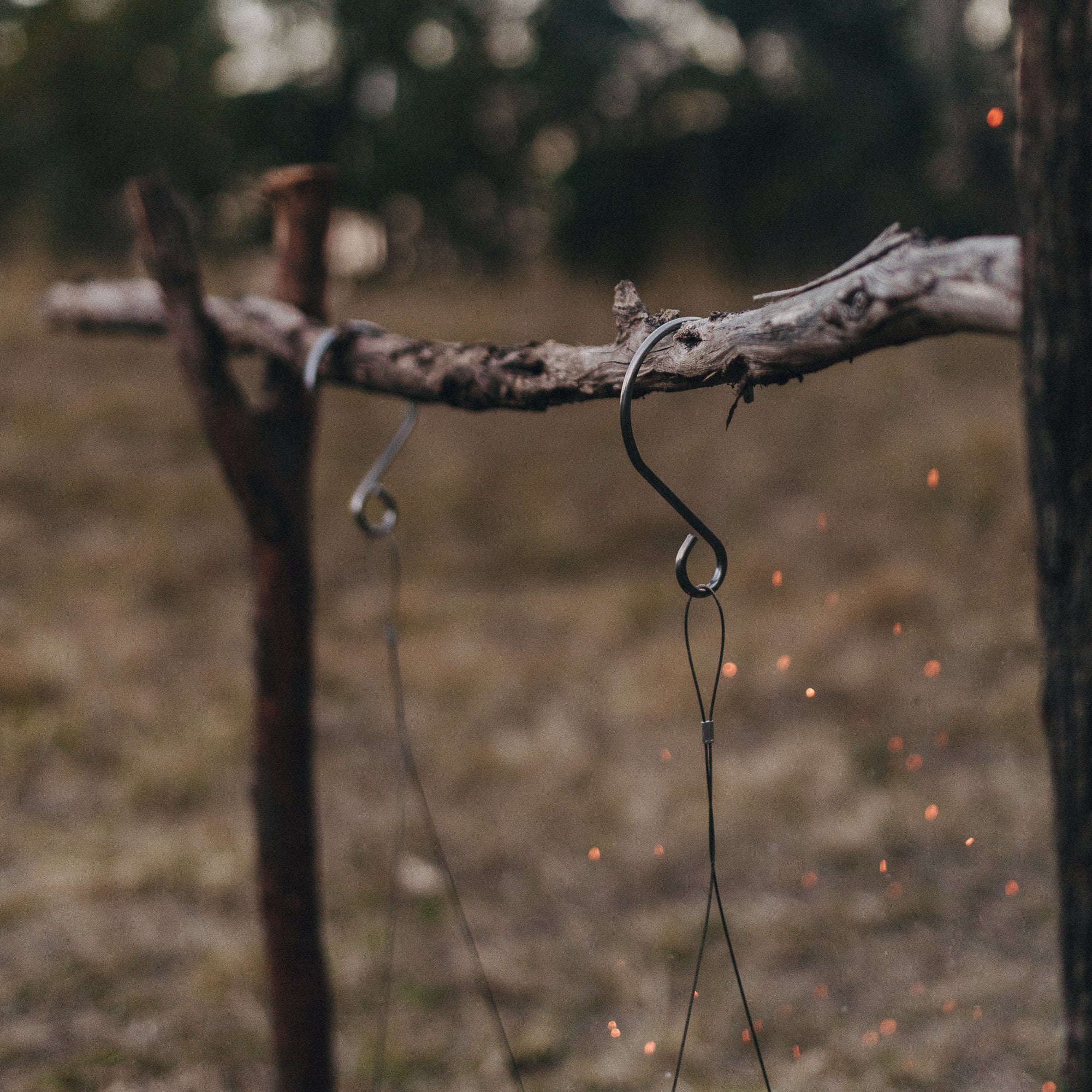 Close up of Alton Goods Ultralight Grill Hangers hooks attached to stick