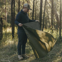 Man folding Alton Goods Ultralight Groundsheet