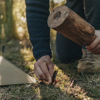 Man hammering in peg