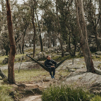 Man sitting in Alton Goods Ultralight Hammock