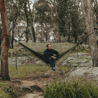 Man sitting in Alton Goods Ultralight Hammock Bug Net