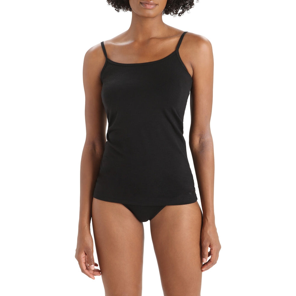 A woman modelling a black Icebreaker cami with thin straps and matching black underwear