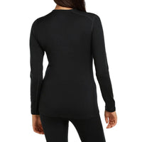 A woman viewed from the back wearing a fitted black Icebreaker long sleeve top and black leggings.
