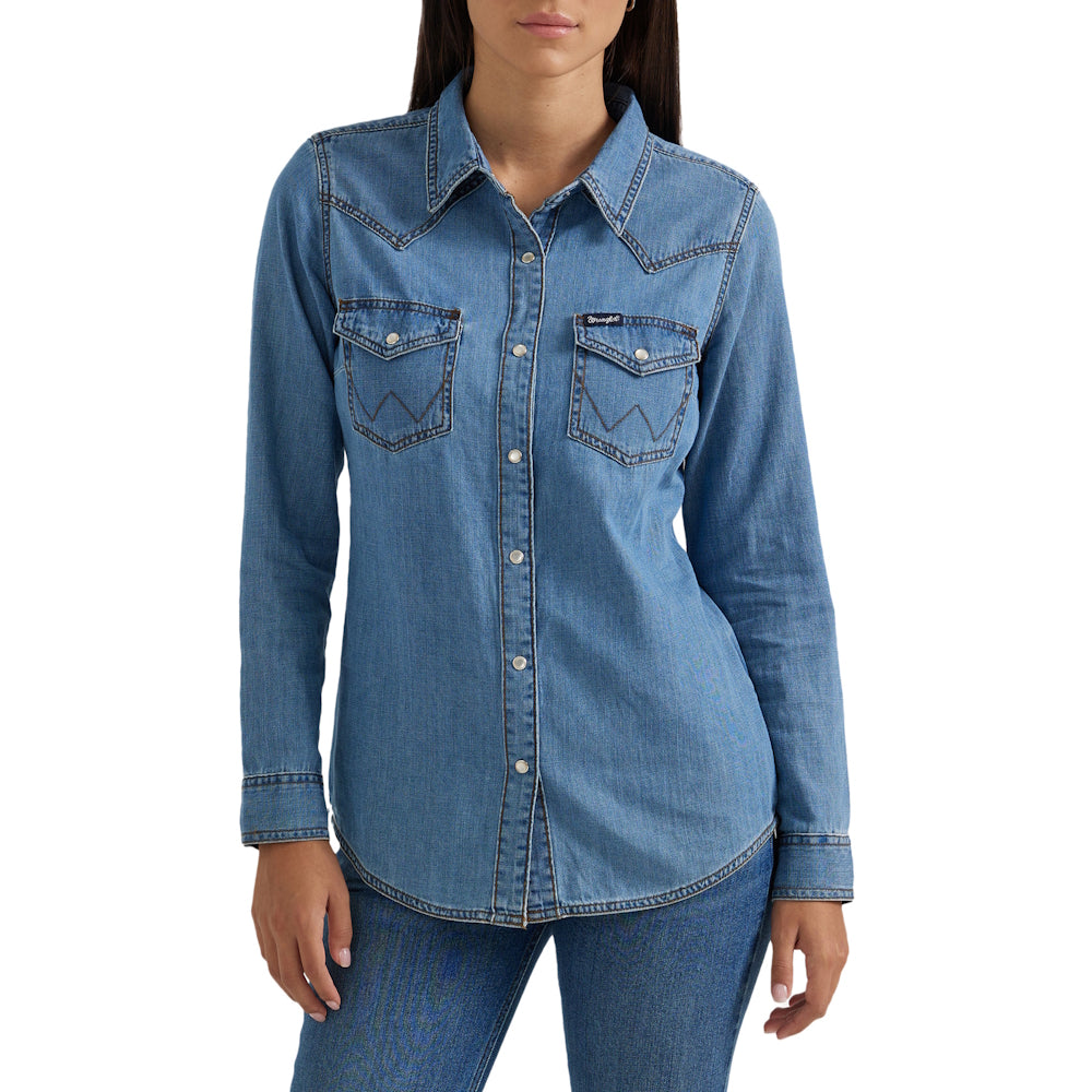 Blue Wrangler denim shirt worn by a woman, matched with denim jeans.