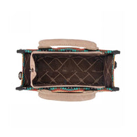 Handbag with colorful patterned interior on a white background