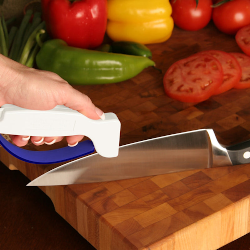 Accusharp Knife Sharpener being used on kitchen knife