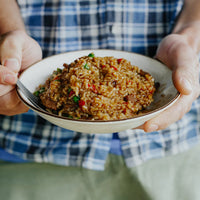 Man holding Back Country Classic Beef Curry in bowl