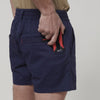 Back view of tool being placed in pocket of Hard Yakka Toughmaxx Short Shorts